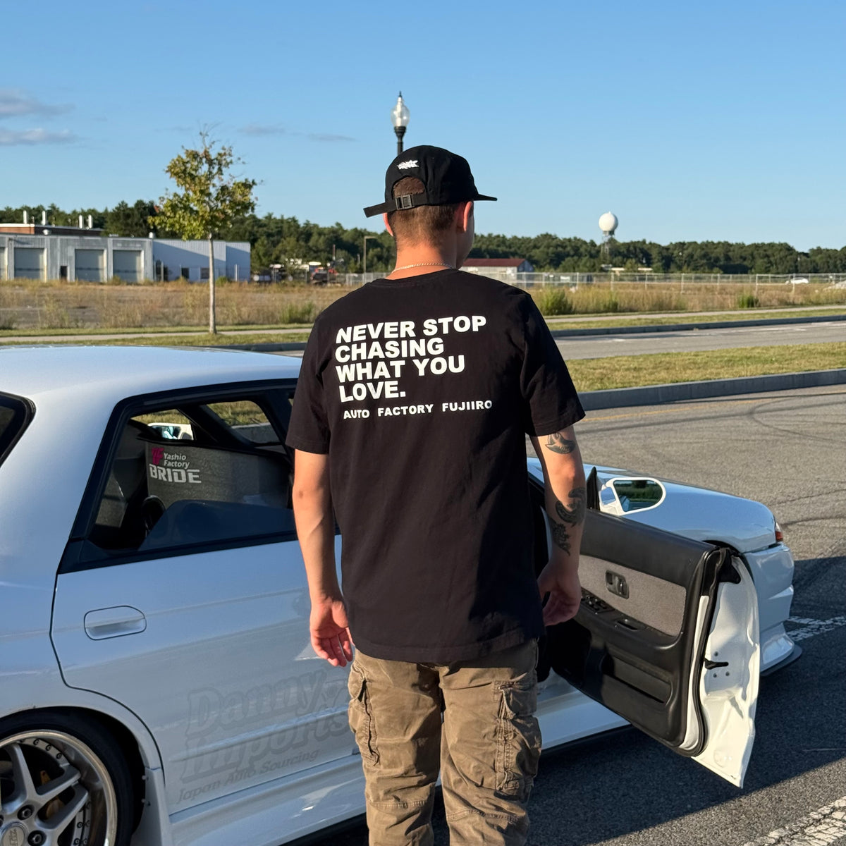 NEVER STOP CHASING WHAT YOU LOVE Tee — Black or White