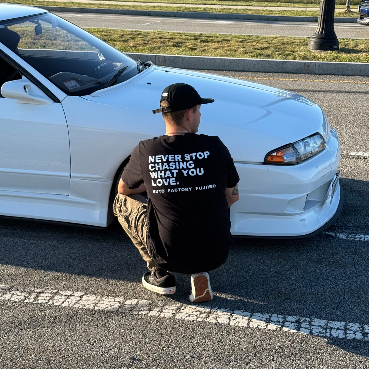 NEVER STOP CHASING WHAT YOU LOVE Tee — Black or White
