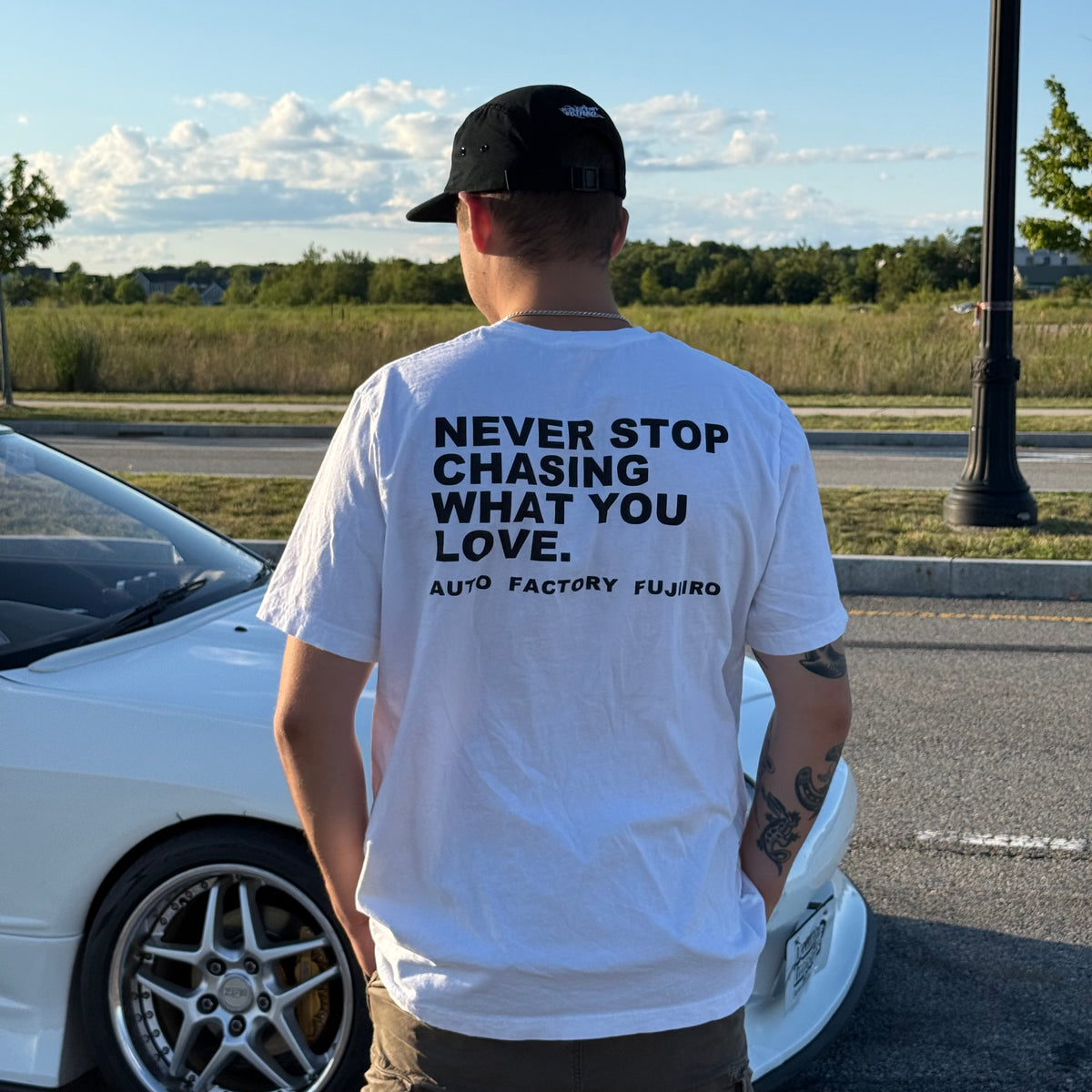 NEVER STOP CHASING WHAT YOU LOVE Tee — Black or White