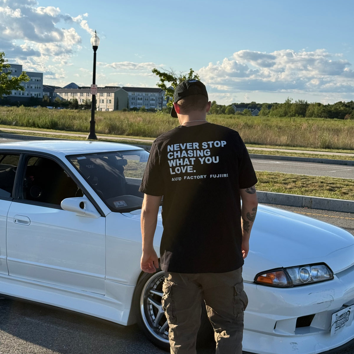 NEVER STOP CHASING WHAT YOU LOVE Tee — Black or White