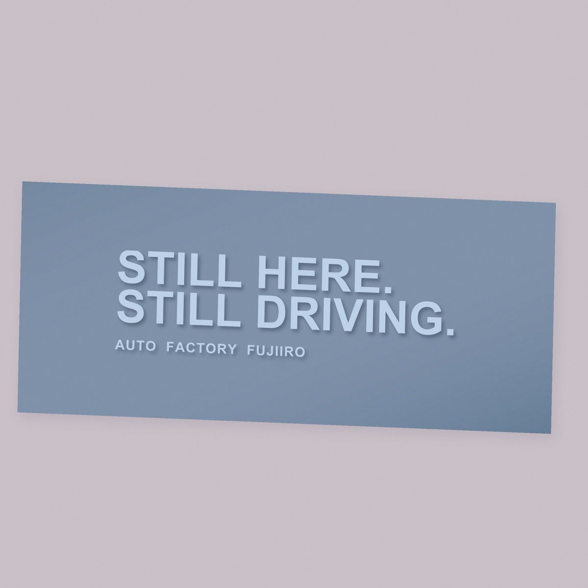 STILL HERE. STILL DRIVING. white die-cut vinyl decal on its transfer sheet