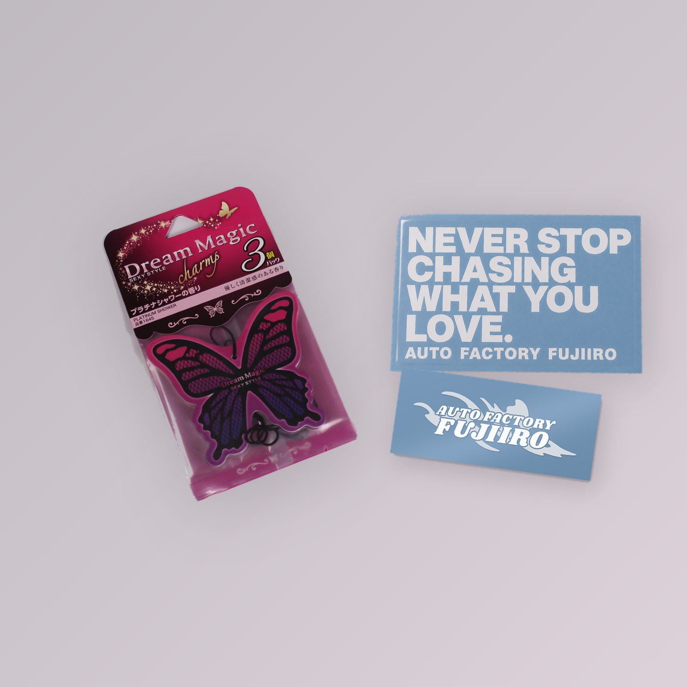 Fujiiro Starter Kit — Dream Magic Platinum Shower air freshener with two 5-inch die-cut vinyl decals, NEVER STOP CHASING WHAT YOU LOVE and Auto Factory Fujiiro Splash, shown to scale