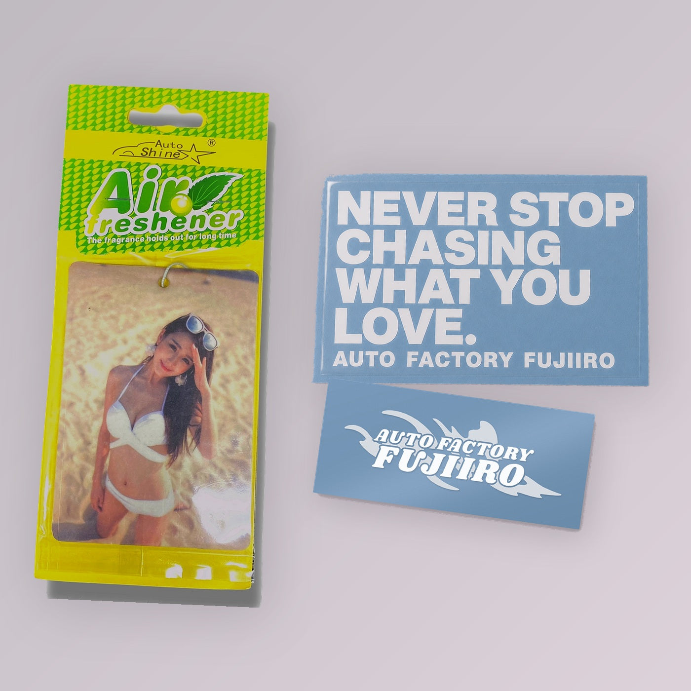 Fujiiro Starter Kit — Japanese Model Lemon air freshener with two 5-inch die-cut vinyl decals, NEVER STOP CHASING WHAT YOU LOVE and Auto Factory Fujiiro Splash, shown to scale