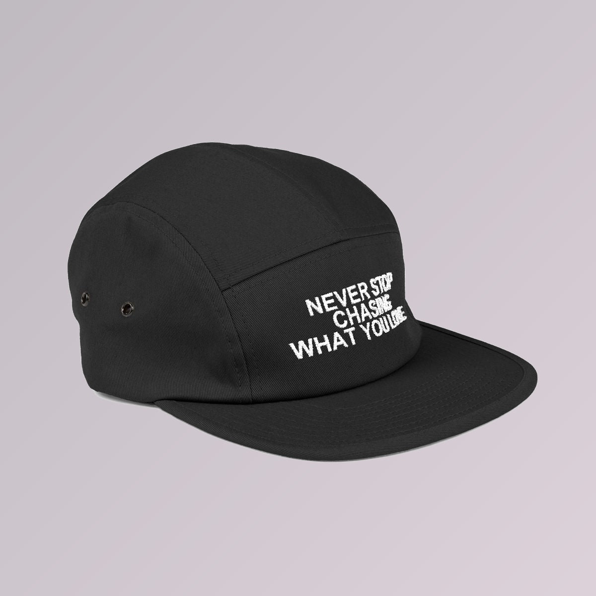 Black — NEVER STOP CHASING WHAT YOU LOVE five-panel cap, side profile showing the flat brim and five-panel crown