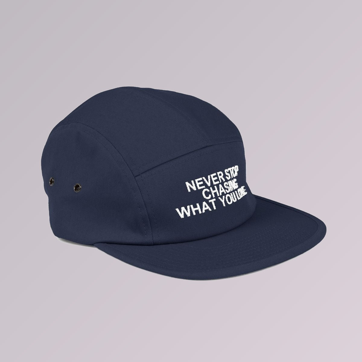 Navy — NEVER STOP CHASING WHAT YOU LOVE five-panel cap, side profile showing the flat brim and five-panel crown