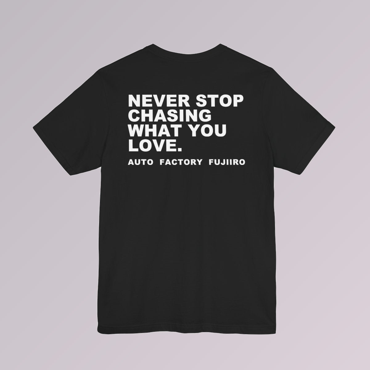 Black — NEVER STOP CHASING WHAT YOU LOVE printed across the back of a black tee